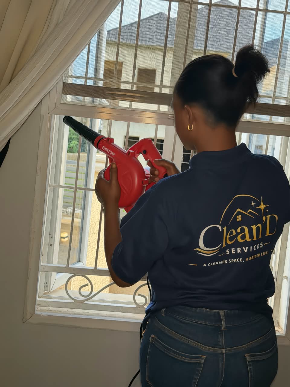 A worker blow cleaning a window